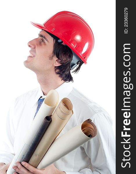 Portrait of young smiling engineer holding blueprints and looking up isolated on white.