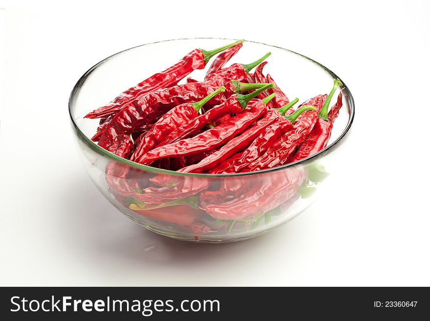 Red chili peppers in the glass bowl,  on white. Red chili peppers in the glass bowl,  on white