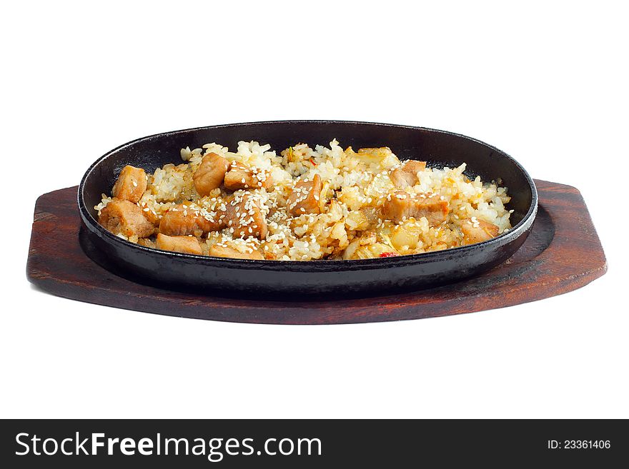 Rice and meat fried in a frying pan on a white background