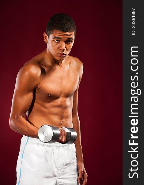 Young fit man lifting dumbell