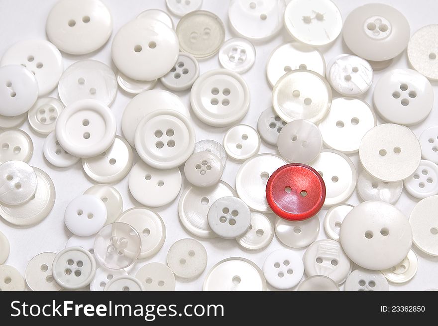 A red button on groupe of buttons in white color on white background.