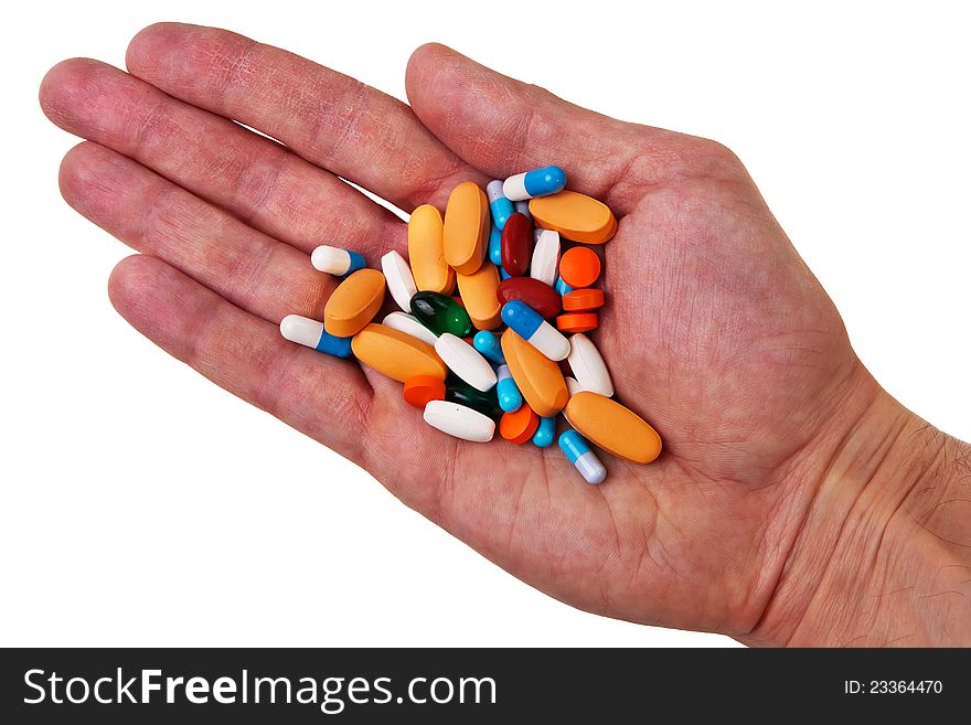 Male white hand with colorful pills and tablets over white background. Male white hand with colorful pills and tablets over white background.