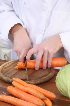 Cutting Carrot With Knife Stock Photos