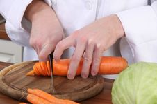 Cutting Carrot With Knife Royalty Free Stock Images