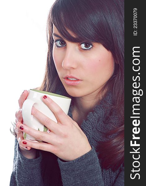 Attractive young girl is enjoying her morning cup of coffee . Against white background .