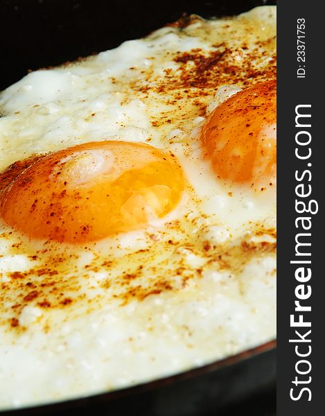 Closeup of fried eggs on pan