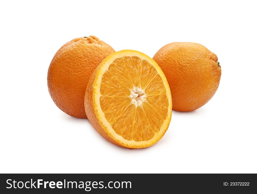 Two oranges and a half of orange in the foreground