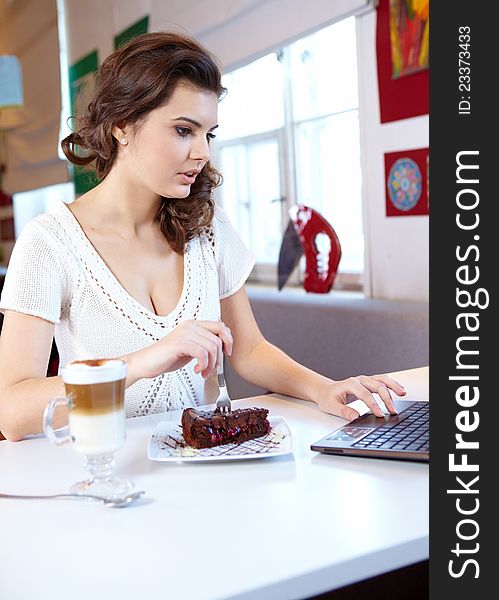 Student woman hold cake at cafe