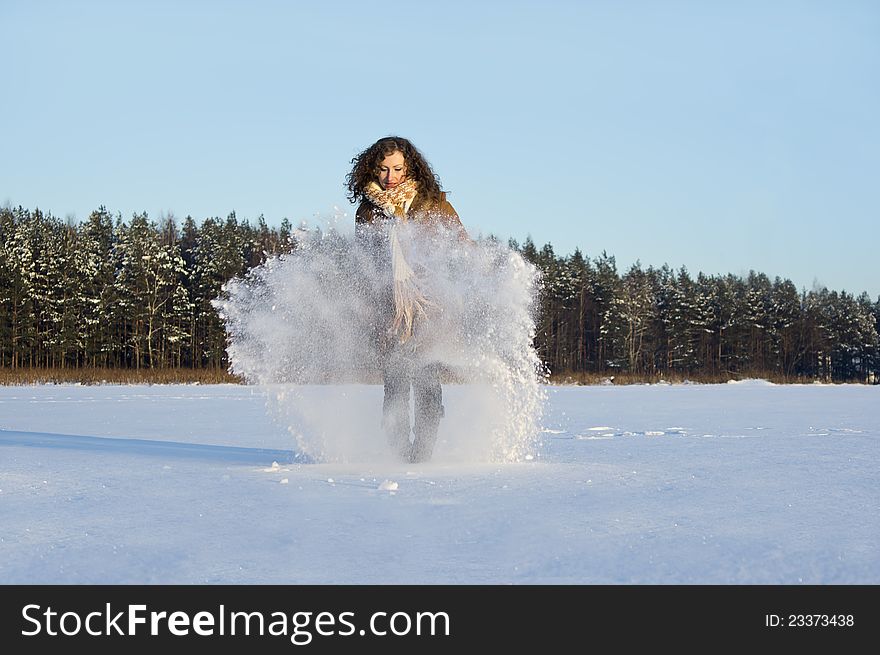 In winter the snow plays a beautiful curly girl. In winter the snow plays a beautiful curly girl