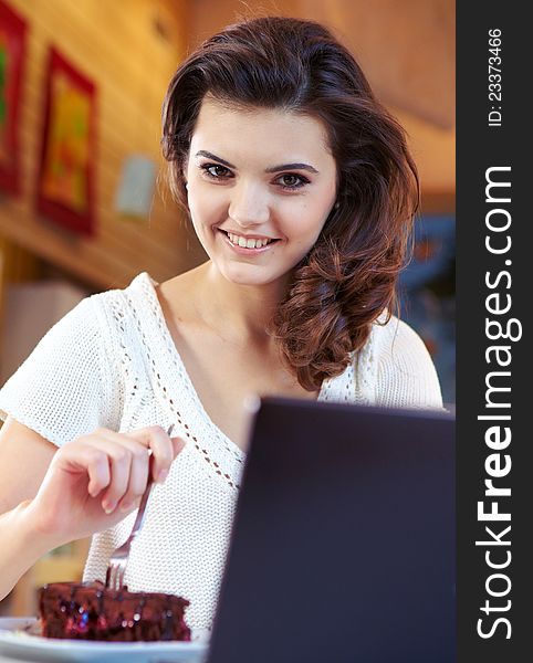 Student woman hold cake at cafe