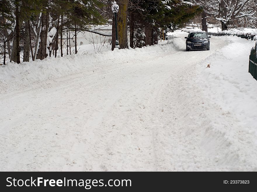 Car driving through a road fully covered in snow. Car driving through a road fully covered in snow