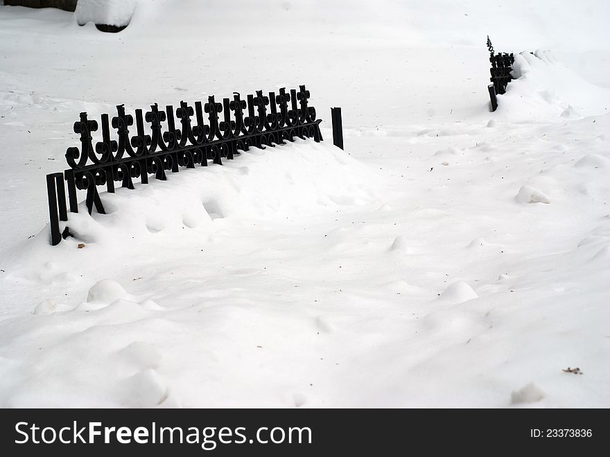 Wrought iron fence covered in snow