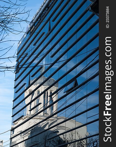 Image of an old church on a modern curtain wall. Image of an old church on a modern curtain wall