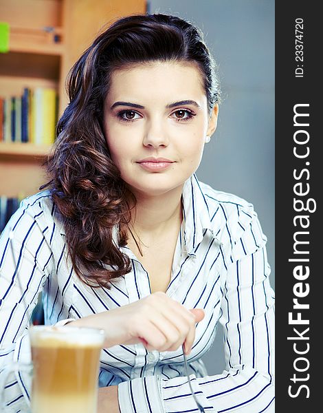 Beautiful young college student on a cafe.