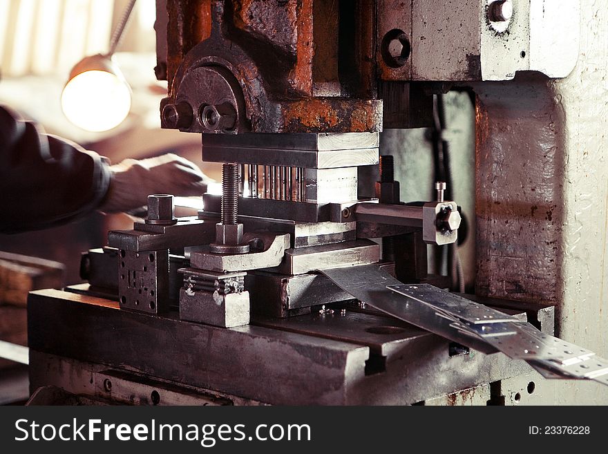 Closeup of heavy metal cutting machinery in a factory