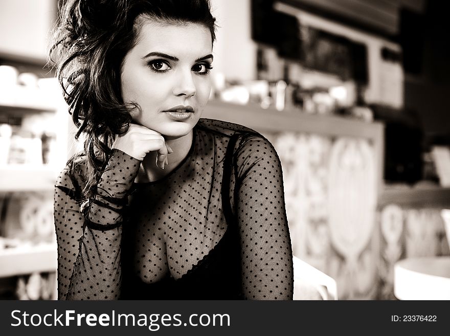 Charming woman in black clothes sits at magnificent cafe restaurant. Charming woman in black clothes sits at magnificent cafe restaurant.