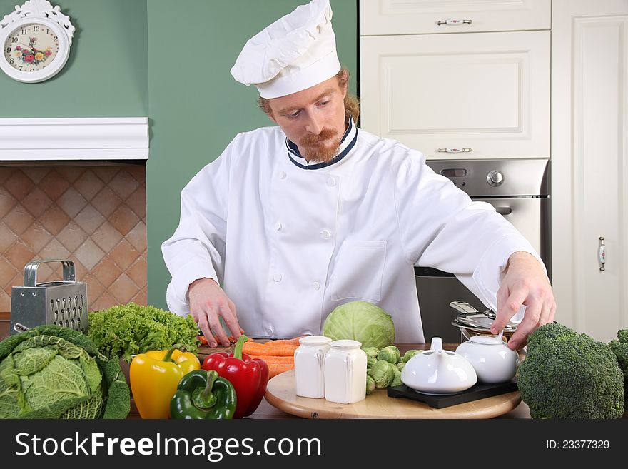 Young chef preparing lunch in kitchen