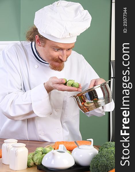 Funny young Chef with Brussels sprouts, preparing lunch in kitchen