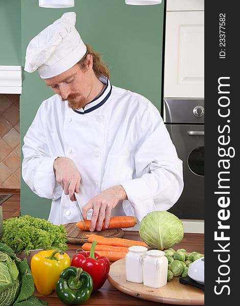 Young chef preparing lunch in kitchen