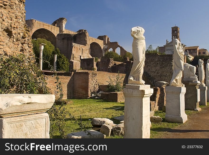 Ancient Roman statues stand on pedestals in the open air in Rome. Ancient Roman statues stand on pedestals in the open air in Rome