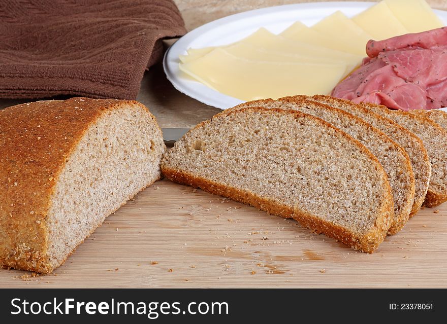 Rye bread sliced on a cutting board for making sandwiches