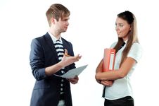 Young Man Explaining Something To Young Woman Stock Photo
