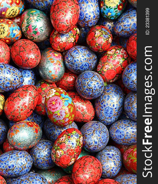 Artificial eggs coloured in different styles as background. Artificial eggs coloured in different styles as background.