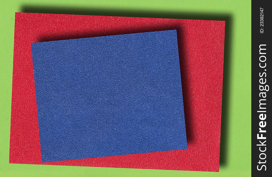 Red and blue abrasive paper on green background paper. Red and blue abrasive paper on green background paper