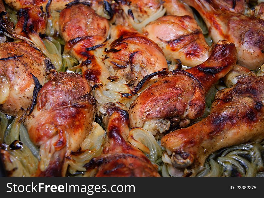 Fresh ripe roasted chicken legs on barbecue pan