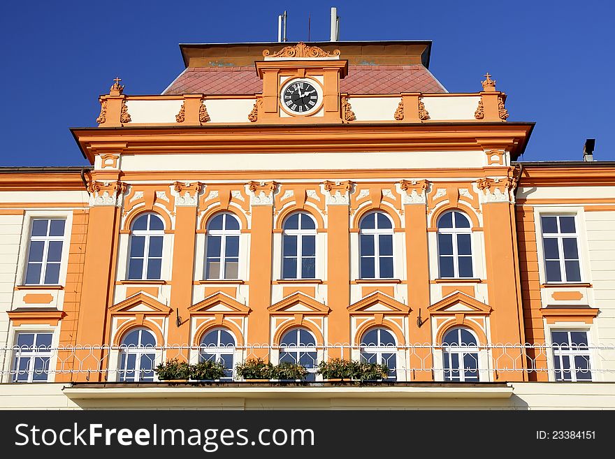 Detail of a middle part of an art nouveau building with balcony and clock. Detail of a middle part of an art nouveau building with balcony and clock