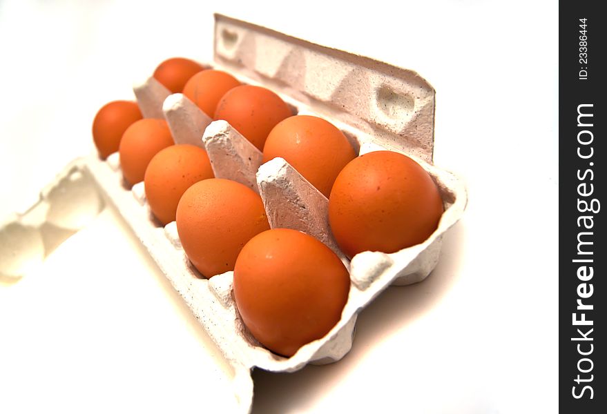 Carton box with eggs on white