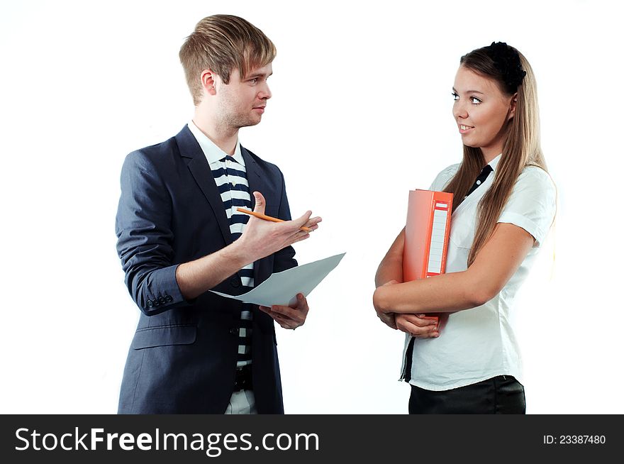 Portrait of a young men explaining something to pretty young women holding paper and pencil isolated on white background. Portrait of a young men explaining something to pretty young women holding paper and pencil isolated on white background