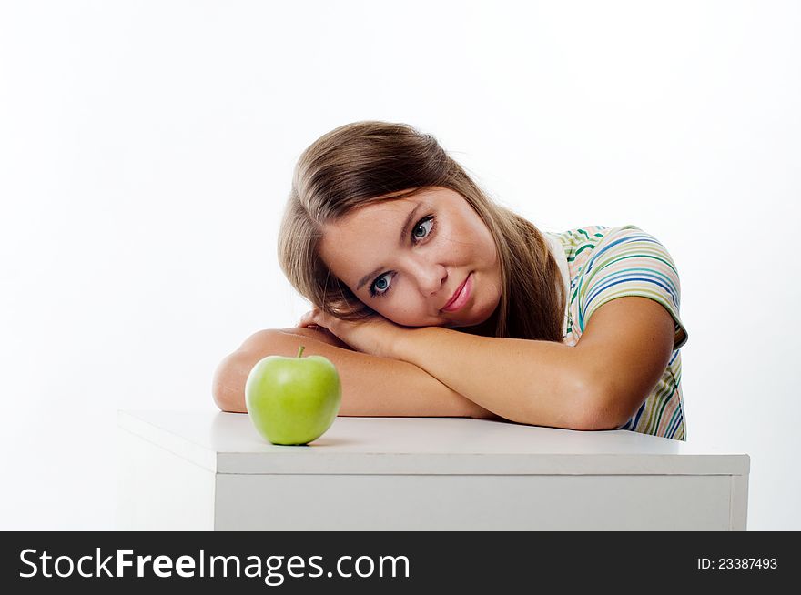 Young Woman Looking At Apple In Front Of Her