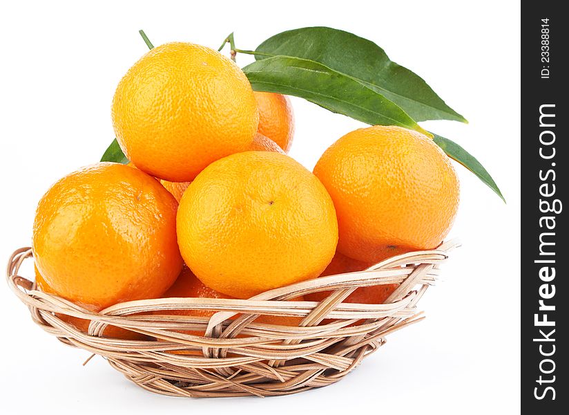 Tangerines with leaves in a beautiful basket  on white