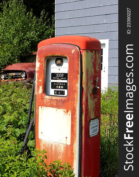 Vintage gas pump and truck at abandoned location