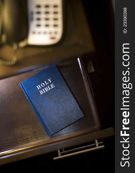 Vertical photograph of a Bible placed in a hotel room. Vertical photograph of a Bible placed in a hotel room