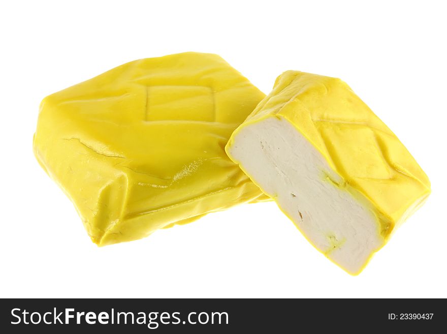 Fresh and Firm Yellow Chinese Tofu coated with turmeric cut in half, isolated on white
