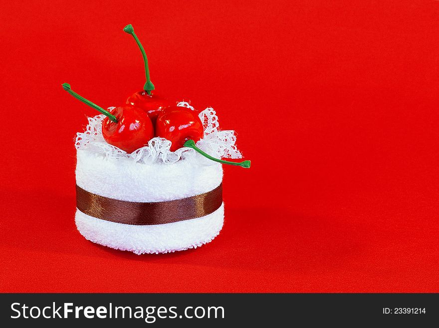 A Towel With A Cherry On A Red Background