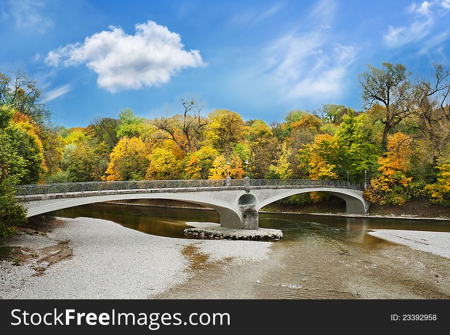 Lonely stone bridge over autumnal scene in Munich. Lonely stone bridge over autumnal scene in Munich