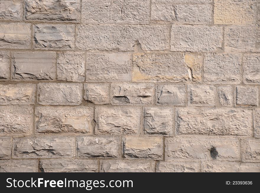 Pattern of grey - light brown limestone wall