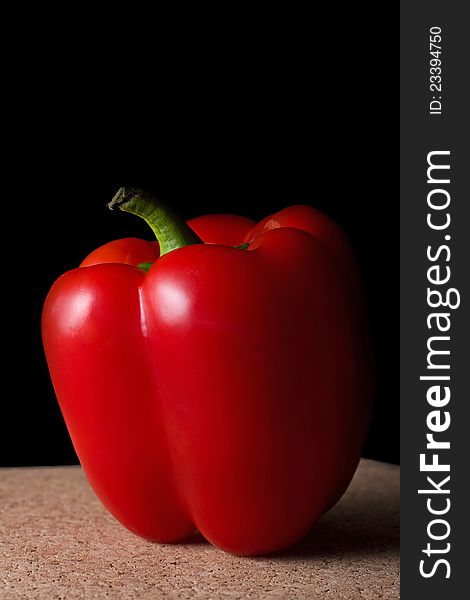 One bell pepper on a table with black studio background