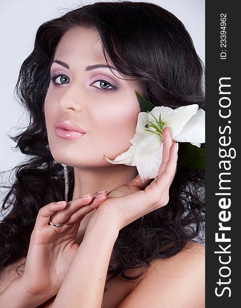 Beautiful young woman with lily flower.