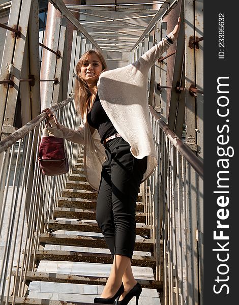 Beautiful girl on the stairs to the roof