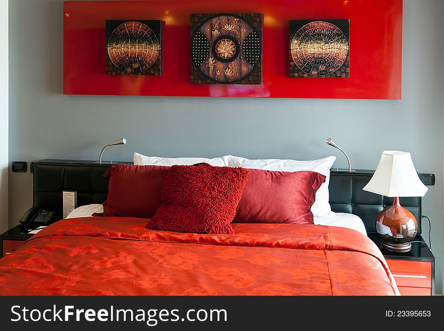 Red luxurious bed in a hotel in Thailand