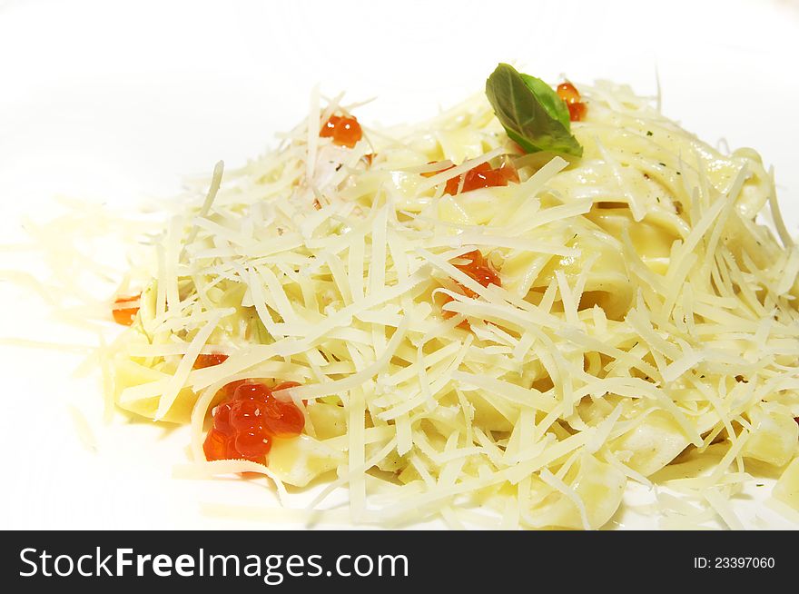 Spaghetti with red caviar on white dish