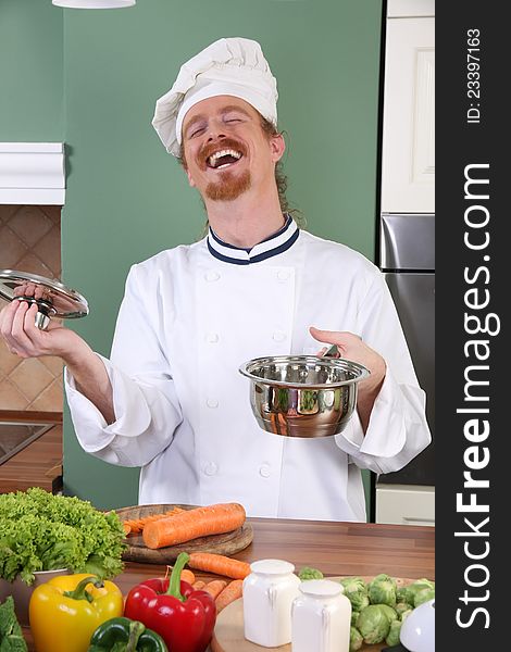 Young chef with vegetables, preparing lunch in kitchen. Young chef with vegetables, preparing lunch in kitchen