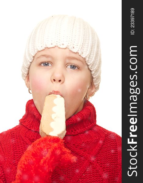 Girl with a winter hat and sweater eating ice cream. Girl with a winter hat and sweater eating ice cream