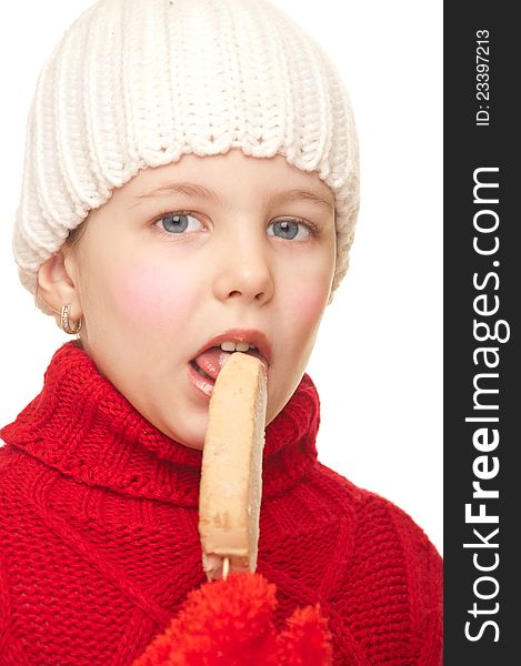 Girl with a winter hat and sweater eating ice cream. Girl with a winter hat and sweater eating ice cream