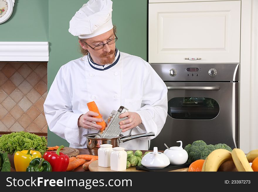 Young chef with vegetables, preparing lunch in kitchen. Young chef with vegetables, preparing lunch in kitchen