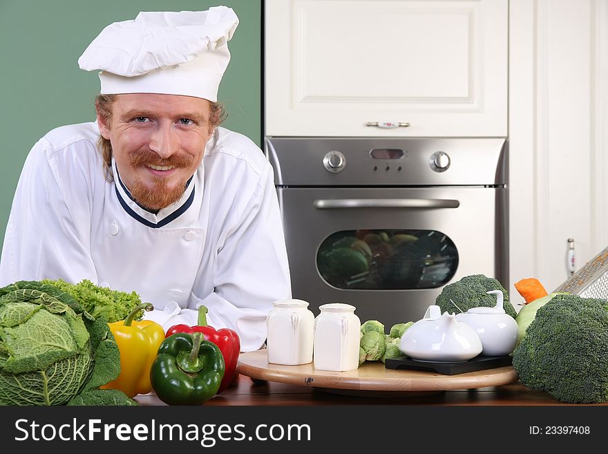 Young chef preparing lunch in kitchen